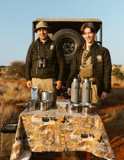 Student serving coffee in the veld